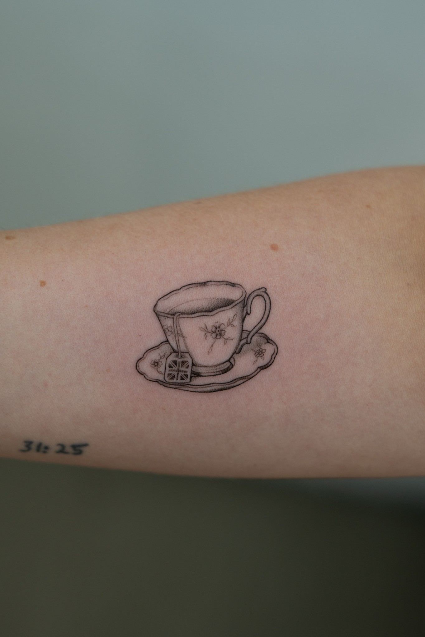 Fine-line teacup tattoo